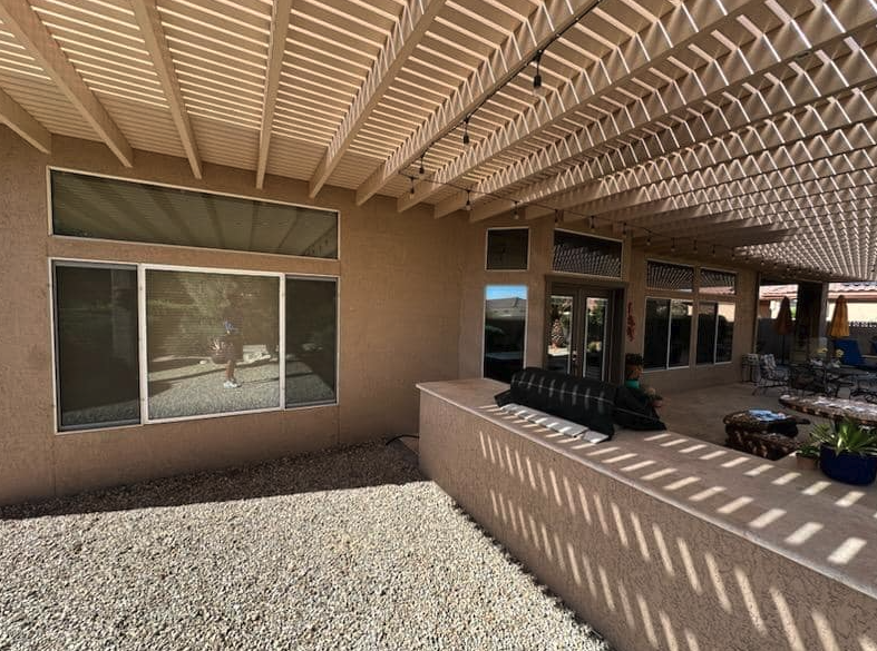 Screened patio windows cleaned under a pergola in Sun City