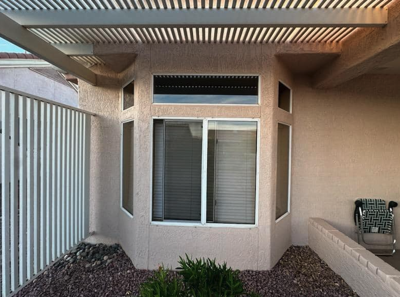 Sliding window cleaned under a louvered pergola in Peoria